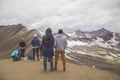 Friends with panoramic views. Hiking scene in Vinicunca, Cusco region, Peru. Montana of Seven Colors, Rainbow Mountain Royalty Free Stock Photo