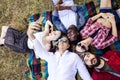 Friends in the park having fun and making a group selfie