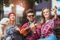Friends in the park having fun playing guitar Royalty Free Stock Photo