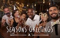 Friends at a party in a bar with Seasons Greetings message