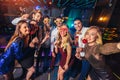 Friends partying in a nightclub make selfie photo