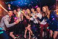 Friends partying in a nightclub and toasting drinks Royalty Free Stock Photo