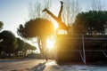 Friends performing freestyle biking and breakdancing at the same time - Break dancer and biker training outdoor in city park -