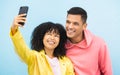 Friends, phone and face with smile for selfie on a blue background for fashion, style or friendship together. Young man Royalty Free Stock Photo