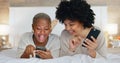 Friends, phone and girls night in bedroom on social media. Happy, smile and black woman on bed with friend watching Royalty Free Stock Photo