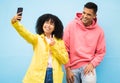 Friends, phone and peace sign for selfie on a blue background for fashion, style or friendship together. Young man and Royalty Free Stock Photo