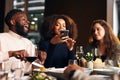 Friends photographing food in restaurant