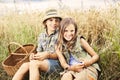 Friends picnicking together in a field of wheat