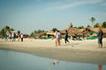 Friends play cricket on the beach of GOA in India. The guys play Indian baseball on the beach. Indian national sport