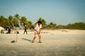 Friends play cricket on the beach of GOA in India. The guys play Indian baseball on the beach. Indian national sport