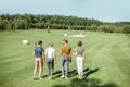 Friends with play equipment on a golf course Royalty Free Stock Photo