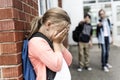 Friends at a playground bullying about other girl in foreground