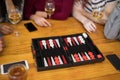 Friends playing backgammon while having glass of wine Royalty Free Stock Photo