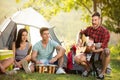 Friends playing drums and guitar front tent Royalty Free Stock Photo