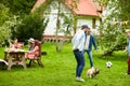 Friends playing football with dog at summer garden Royalty Free Stock Photo