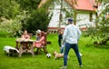 Friends playing football with dog at summer garden Royalty Free Stock Photo