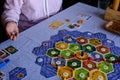 Friends playing settlers of catan board game