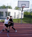 Friends playing street basketball