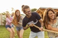 Friends playing tug of war at an outdoor summertime party Royalty Free Stock Photo