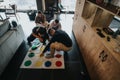 Friends playing Twister game in cozy home environment, fun and leisure concept Royalty Free Stock Photo