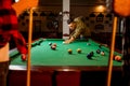 Friends plays american billiard in poolroom