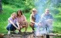 Friends prepare roasted sausages snacks nature background. Company hikers at picnic roasting sausages on sticks. Camping