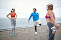 Friends preparing for a training on the beach Royalty Free Stock Photo