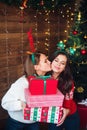 Friends presenting gifts each other near Christmas tree Royalty Free Stock Photo