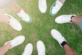 Friends putting their shoes together in a circle. Youth in white sneakers Royalty Free Stock Photo