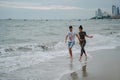 Friends or relatives rest on the ocean coast. Cheerful, beautiful, young, loving couple spends time on vacation. Fun on