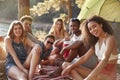 Friends relaxing on a blanket by a lake, close up Royalty Free Stock Photo