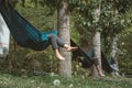 Friends relaxing in hammocks tied to the trees of a campsite on a sunny day Royalty Free Stock Photo