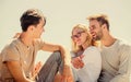 Friends relaxing on roof. Men and woman talking sky background. Spending time with friends. Summer vacation. Discussing Royalty Free Stock Photo