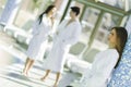 Friends relaxing in a spa next to a swimming pool Royalty Free Stock Photo