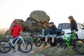 Friends Resting near Pickup Off Road Truck after Bike Riding in the Mountains at Sunset. Adventure and Travel Concept. Royalty Free Stock Photo