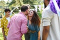 Friends reunite after a long time apart. Men and women embracing, happy to meet at garden party. Royalty Free Stock Photo