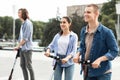 Friends riding motorized kick scooters in the city Royalty Free Stock Photo