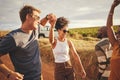 Friends, road trip and dance with a man and woman on a vacation, holiday or getaway in the dessert on a sand road Royalty Free Stock Photo