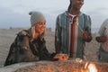 Friends roasting marshmallows at the beach Royalty Free Stock Photo