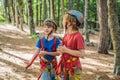 Friends on the ropes course. Young people in safety equipment are obstacles on the road rope Portrait of a disgruntled