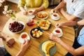 Friends at Round Table with Tea and Snacks Royalty Free Stock Photo