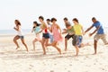 Friends Running Along Beach Together