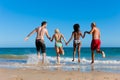 Friends running on beach vacation Royalty Free Stock Photo