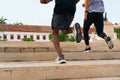 Friends running stairs together during workout in park Royalty Free Stock Photo