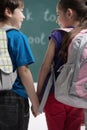 Friends at school class. Rear view of classmates holding hands a Royalty Free Stock Photo