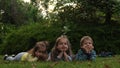 Friends selfie. Excited young children siblings Laying on grass meadow. Little brother and sister monkeying on camera