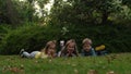 Friends selfie. Excited young children siblings Laying on grass meadow. Little brother and sister monkeying on camera Royalty Free Stock Photo