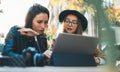 Friends shopping online on wifi tablet in cafe outdoor. Students studies on internet. Working business process concept Royalty Free Stock Photo