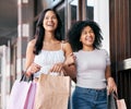 Friends, shopping and walking with bags in city, luxury and fashion retail store outdoor with happy smile. Women Royalty Free Stock Photo