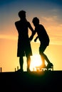 Friends silhouette at skate park on summer day Royalty Free Stock Photo